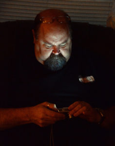 Illuminated by the rear screen of his camera, Tony Vaselaros makes sure his equipment functioning properly.