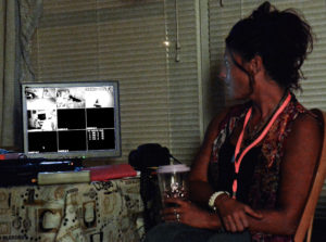 Nicole Vaselaros keeps an eye on the monitor which has three infrared night vision security cameras feeding images into the central control position in the client's living room.